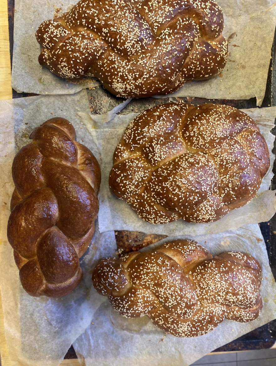 Several glossy challah loaves